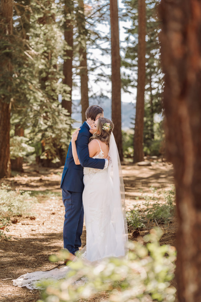 Lake Tahoe, California mountain, forest and beach wedding with the most beautiful wooden mountain peak arch decor. This was considered a fairly intimate small wedding. The views did not disappoint and neither did the bride in her gorgeous romantic A line wedding dress. Photographed by Bay Area photographer, Kati Douglas with Xilo Photography in Oakland, CA