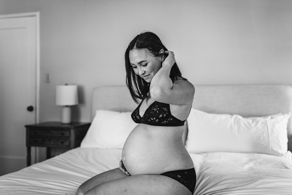 Intimate boudoir maternity session featuring a pregnant mother to be in her master bedroom in the San Francisco Bay Area by Intimate Photographer Xilo Photography in Oakland California