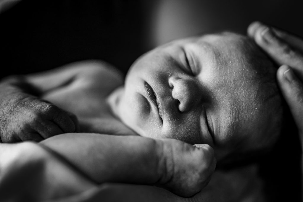Up Close Sleeping Newborn Portrait that showcases a documentary style of newborn photography taken by Xilo Photography in Oakland, CA - based in San Francisco Bay Area and photographing newborn and families all over the Bay Area